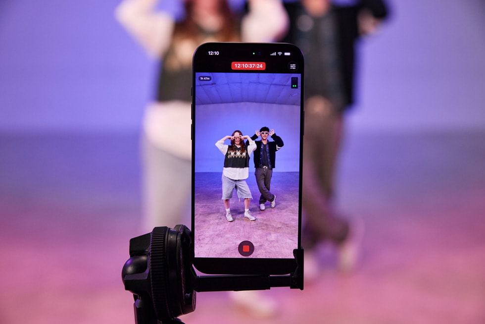 Eine Nahaufnahme eines iPhone 17 Pro Max auf einem Stativ zeigt eine Live-Aufnahme von Kyle Hanagami und einem:r T?nzer:in, die in einem Studio ihre Moves vorführen.